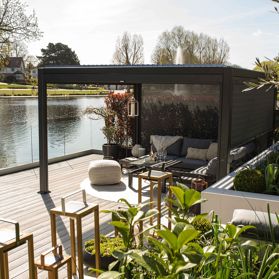 A chic black metal pergola on wooden decking with a black cover on the side of the pergola.
