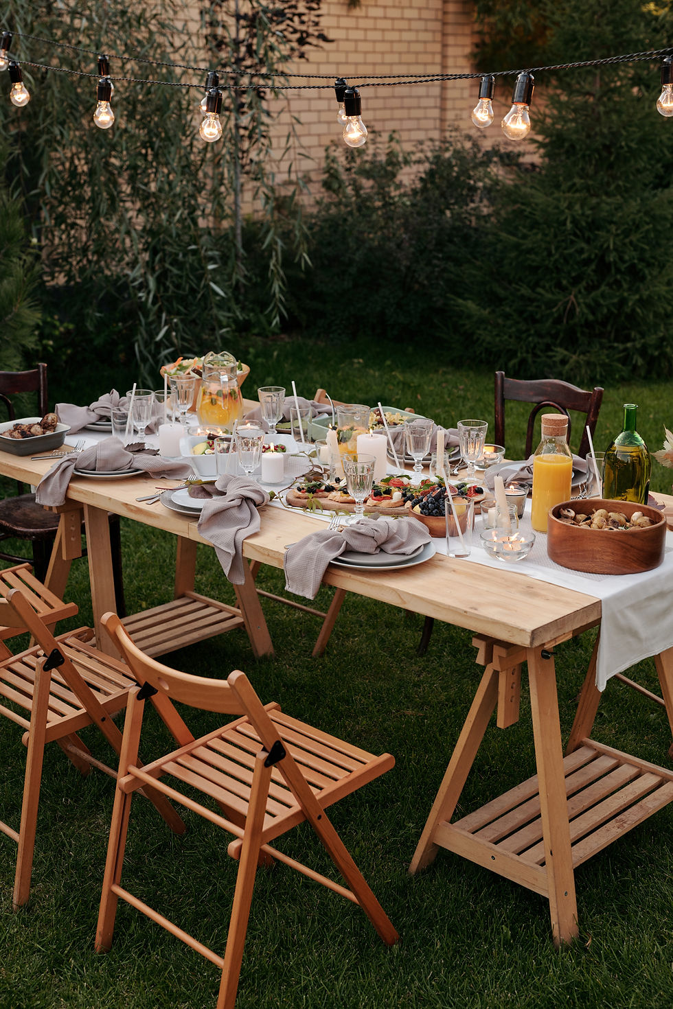 A garden table in a lit up garden in an idyllic setting.